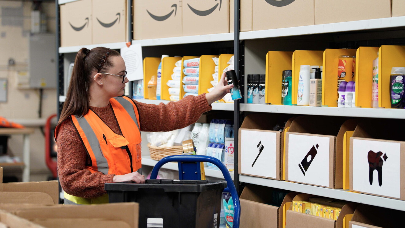 A volunteer stocks shelves at the newest Amazon Multibank in Swansea