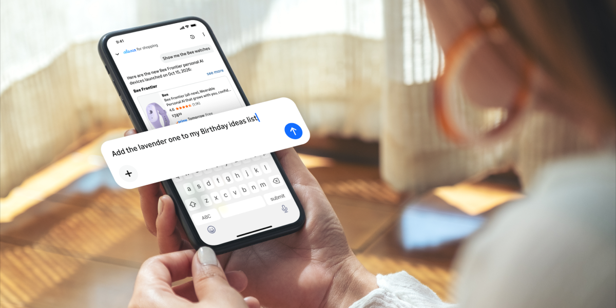 A person holds a phone showing the Alexa for Shopping chat, with a typed request to add an item to a birthday ideas list