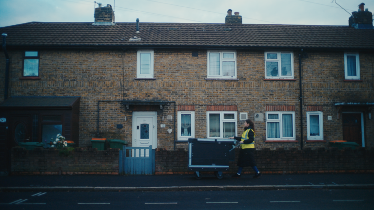 An Amazon worker delivering on foot