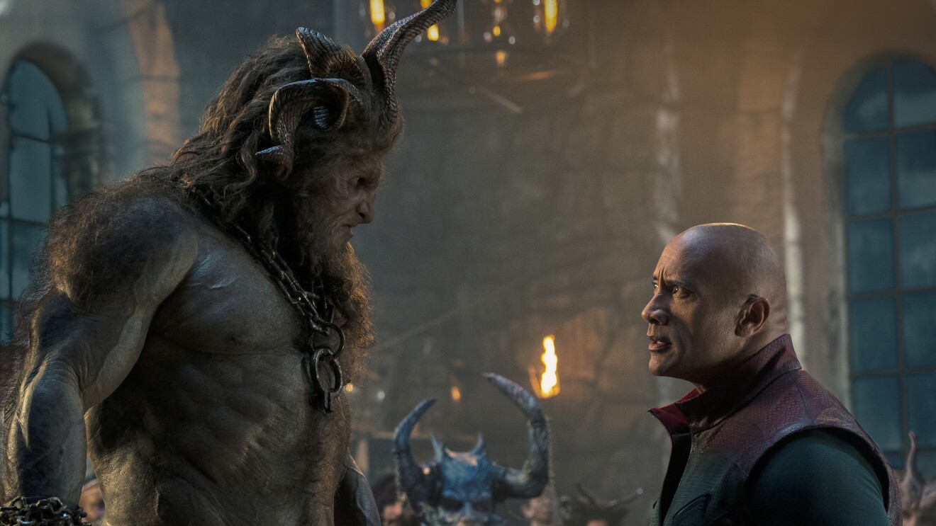 Red One: Monstrous creature towers over human in atmospheric fantasy scene