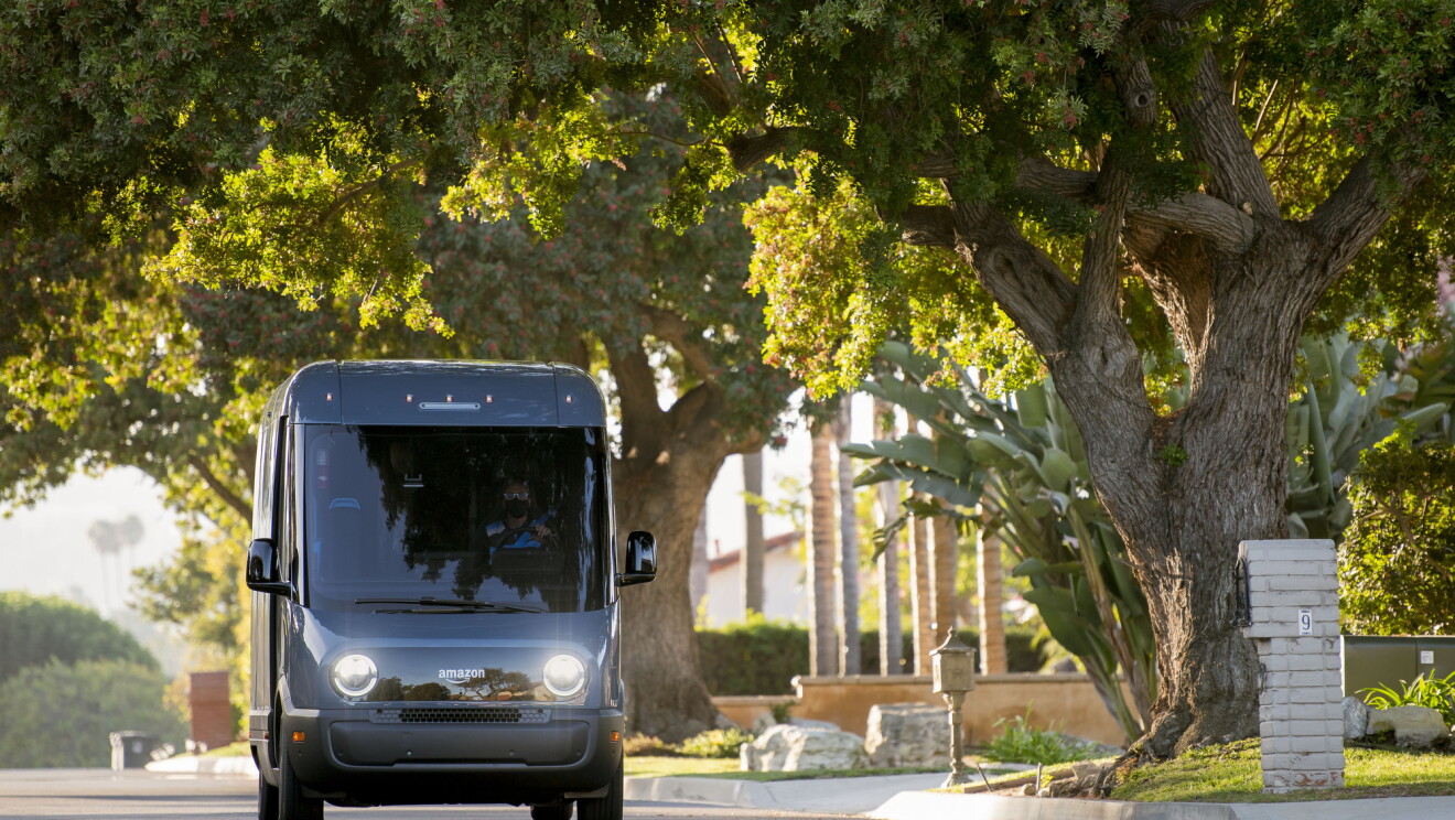 An Amazon-branded Rivian vehicle drives through the streets in Southern California.