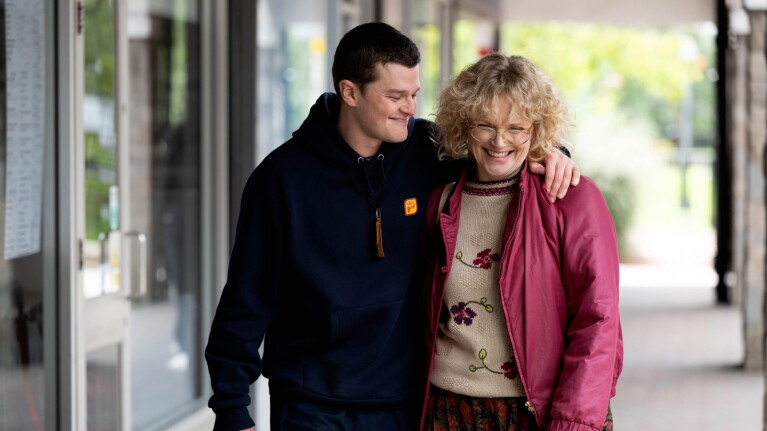 Robert Aramayo (John Davidson) and Maxine Peake (Dottie Achenbach) embraced and smiling