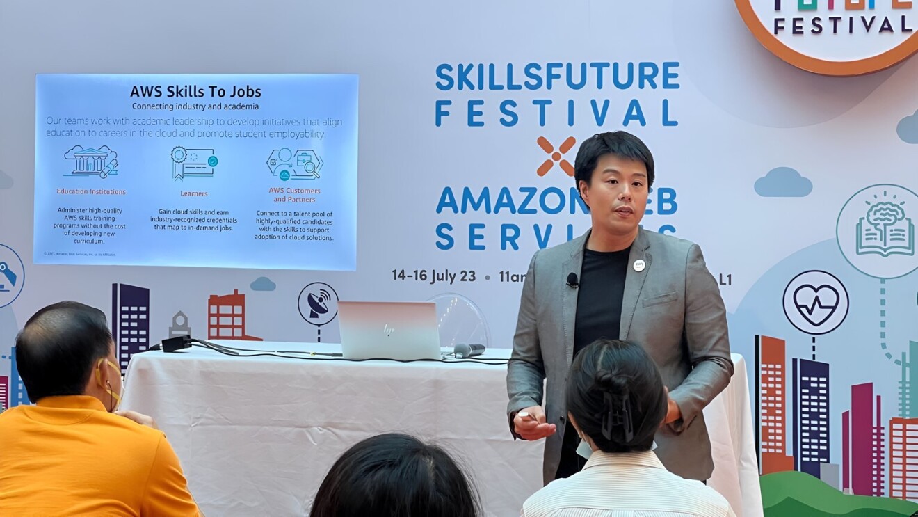 Ricky Tan speaking about the AWS Skills to Jobs program at the SkillsFuture SG x AWS Roadshow in Singapore to a crowd of interested people