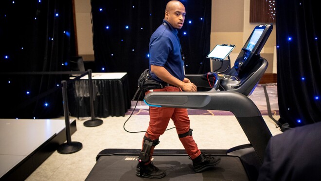 An image of a man walking on a treadmill with devices hooked up to him.