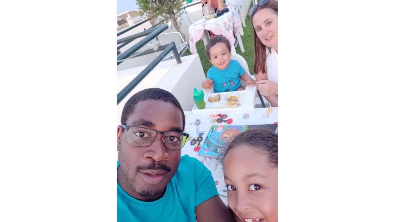 Bode takes a selfie of him and his two children and partner while eating a meal together.