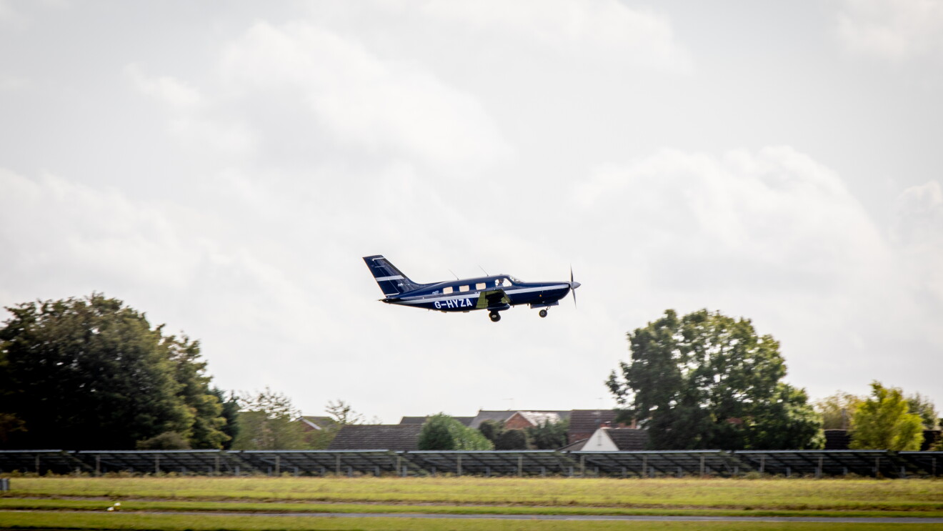A small plane taking off or landing on a small airfield. 