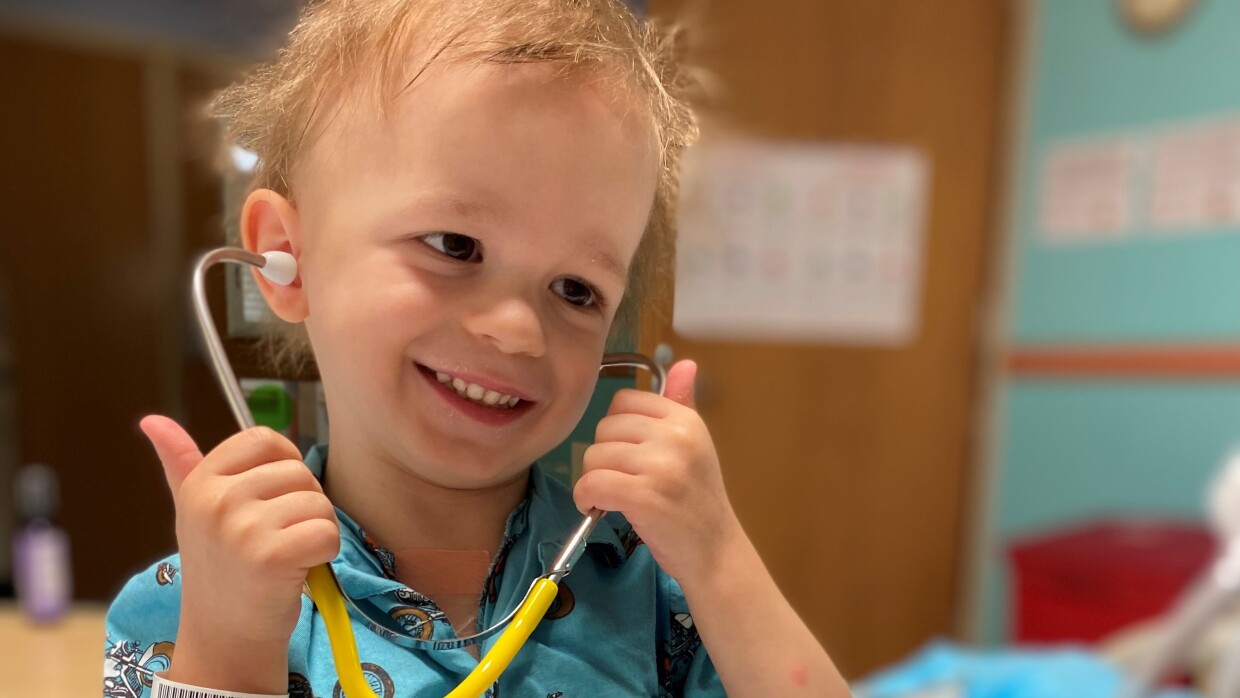 Photograph of little Wes, playing with medical equipment in the hospital