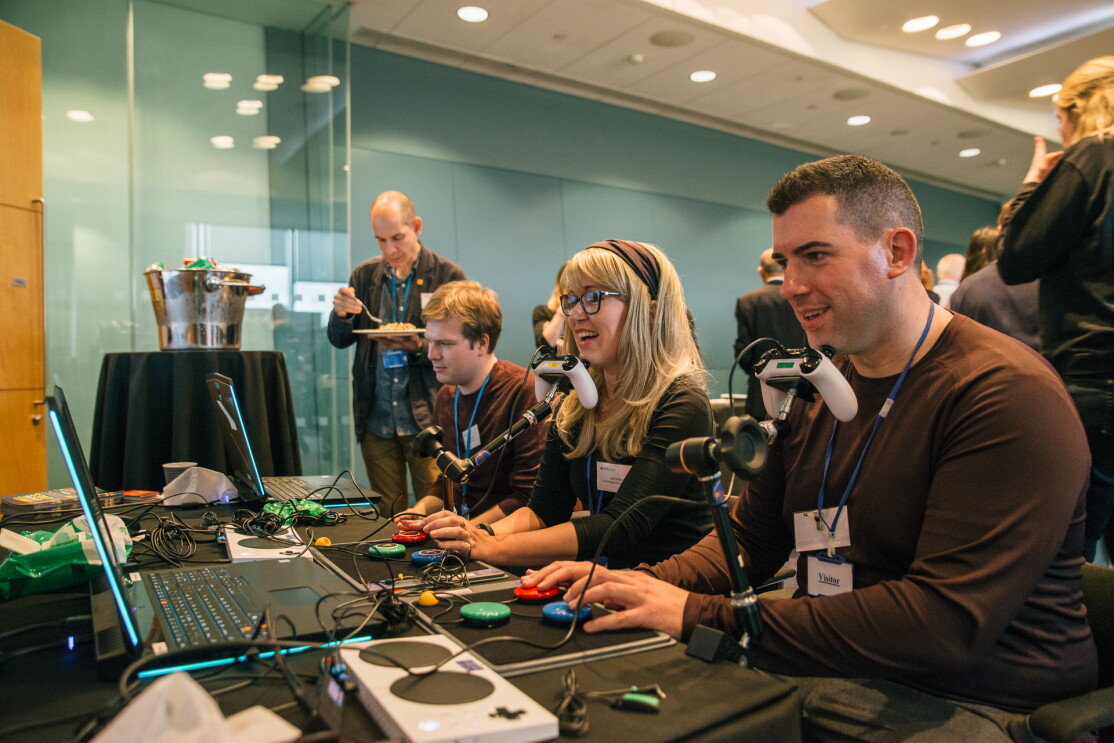 People playing on adapted games kit run by Special Effect at TechShare Pro 18.