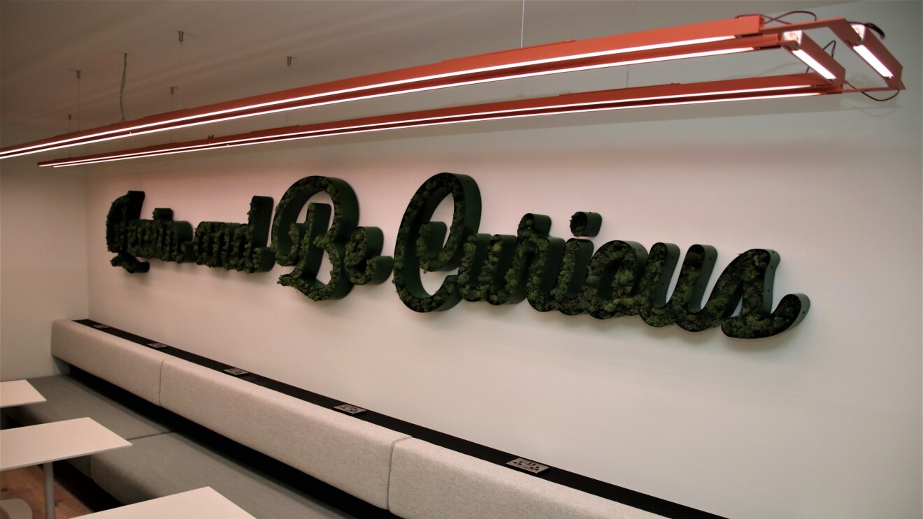 Sign at the Amazon Manchester offices reading "Learn and Be Curious"