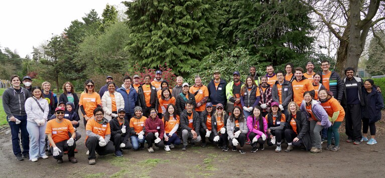 An image of a group of people volunteering in a park