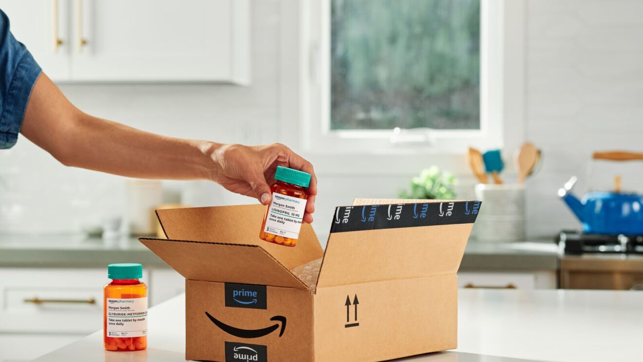 Hand removing prescription bottle from Amazon Prime delivery box