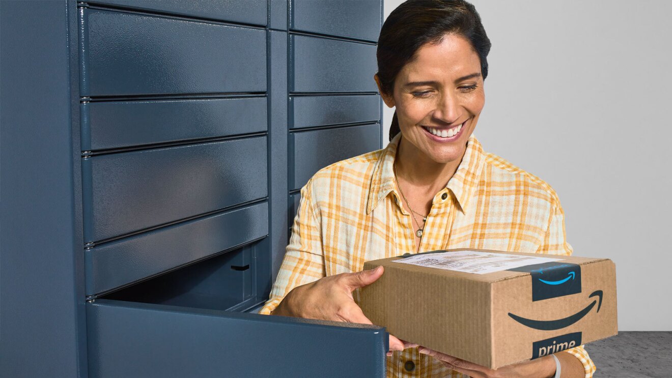 A brown-haired woman in a plaid yellow shirt picks up her Amazon package at a Locker. 