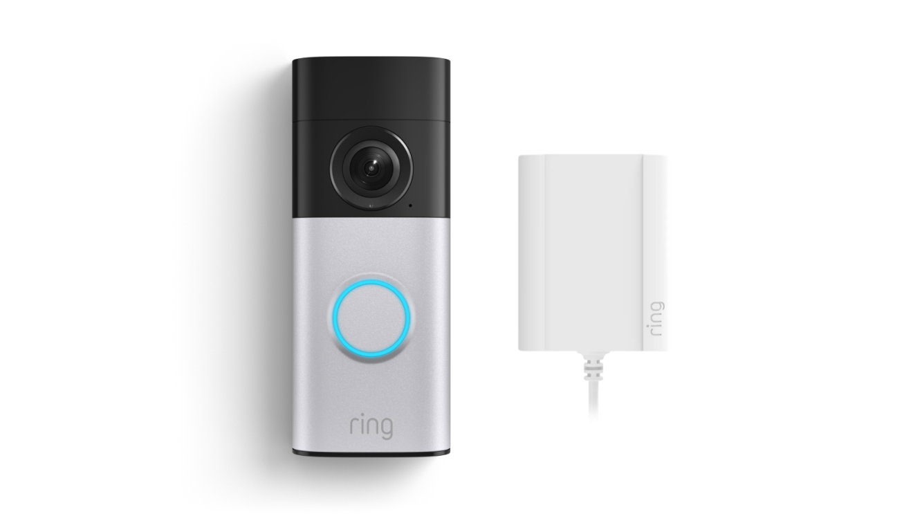 Sonnette vidéo Ring avec caméra et bouton lumineux bleu accompagnée de son unité de chargement
