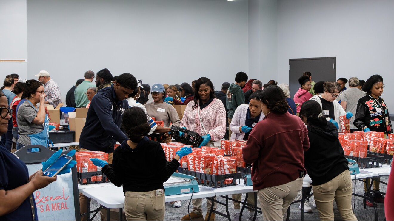 Volunteers packing meals at community service event