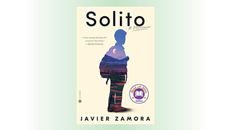 The cover photo for the book, "Solito: A Memoir" by Javier Zamora. The cover includes a silhouette of a person wearing a backpack. Within the silhouette is an image of a mountain valley in the evening, with the moon between the mountains.