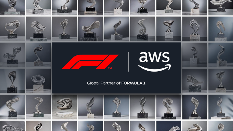 F1 and AWS logos in front of trophy designs.