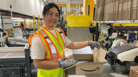 Amazon associate packing orders at Amazon fulfilment centre