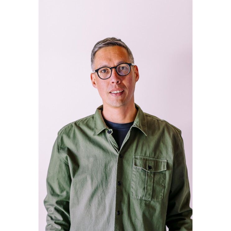 A guy with green shirt and glasses.