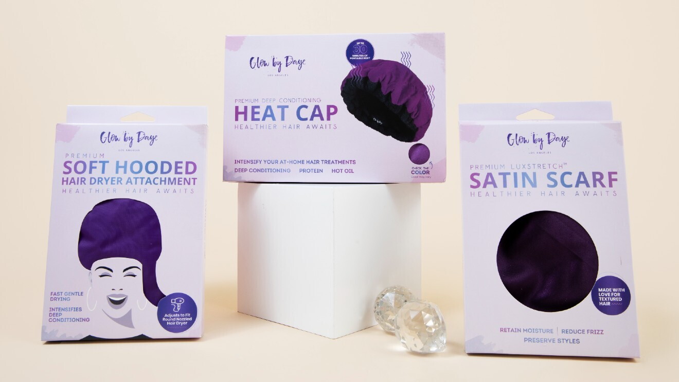 A photo of Glow by Daye products, including a soft hooded hair dryer attachment, heat cap, and satin scarf.