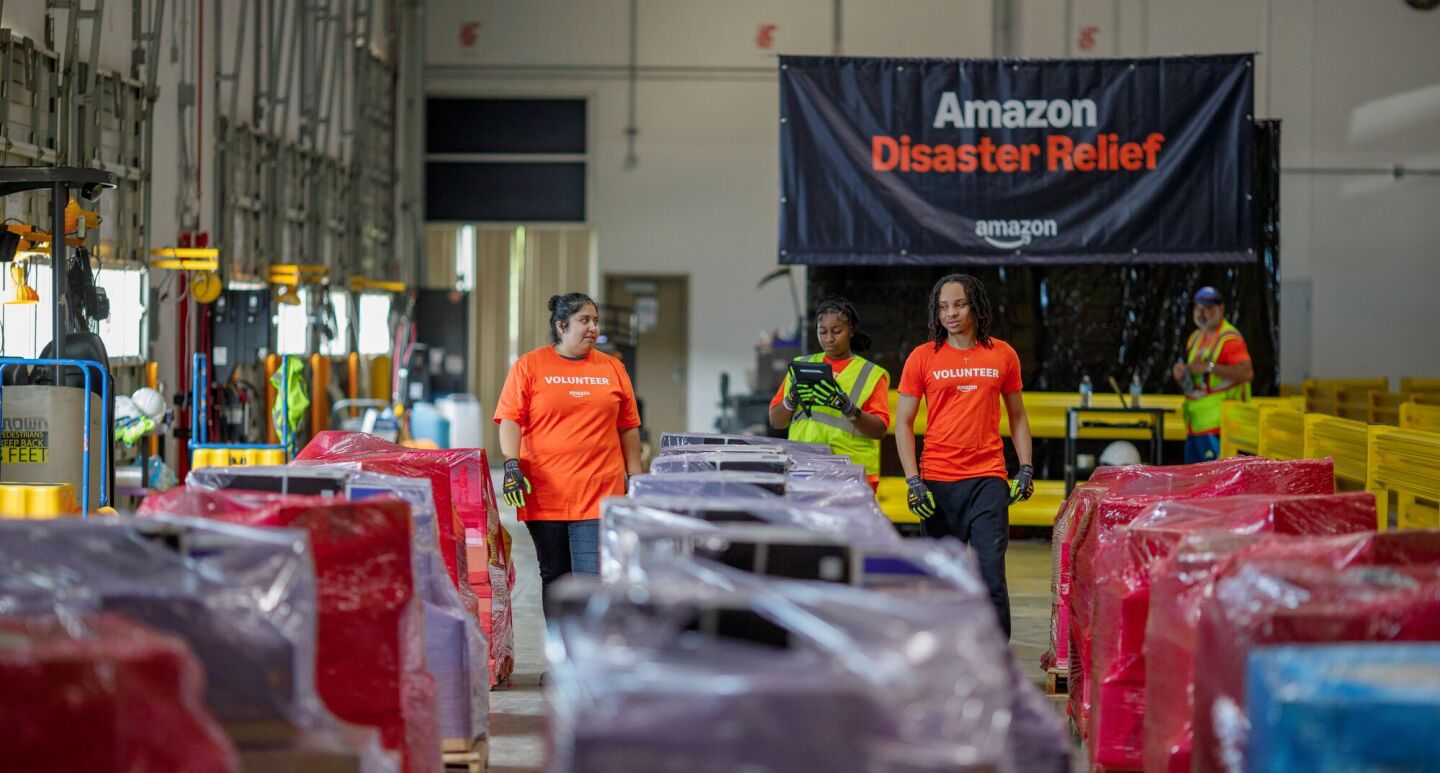 Amazon Disaster Relief volunteers organize supplies in warehouse