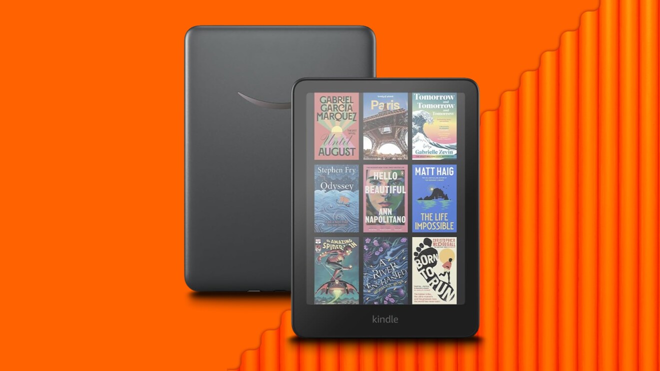 Kindle Colorsoft e-reader displaying multiple book covers on vibrant orange background