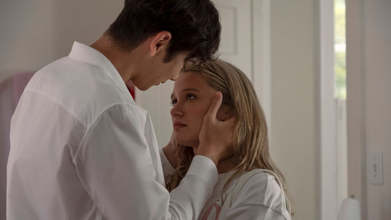 Steven (Sean Kaufman) and Taylor (Rain Spencer) in white clothing sharing an intimate moment