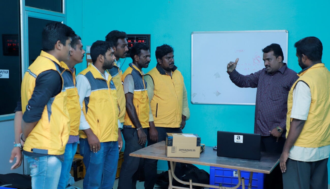 Service Partner speaking with his associates in his office