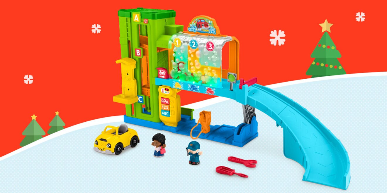 An image of a Fisher-Price playset. It's a colorful, setup showing a car maintenance shop complete with a lift, a yellow car, a car wash, a slide, and two figurines of a customer and a mechanic holding a wrench. There are also two red tools--a wrench and a screwdriver--for the kid to use.
