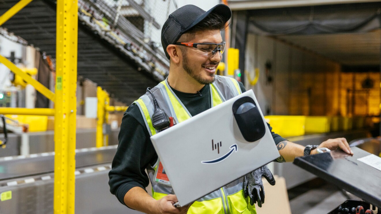 An Amazon employee works in a fulfillment center.