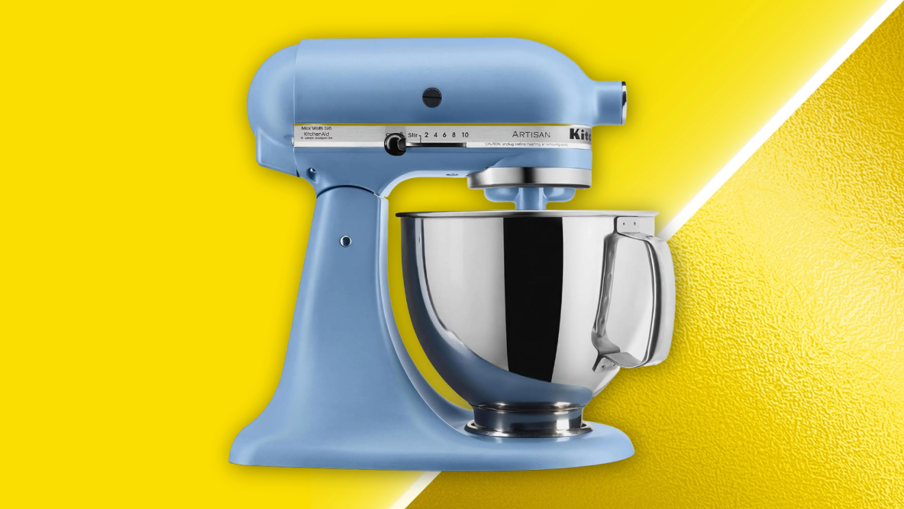 Blue KitchenAid Artisan stand mixer with stainless steel bowl on yellow background