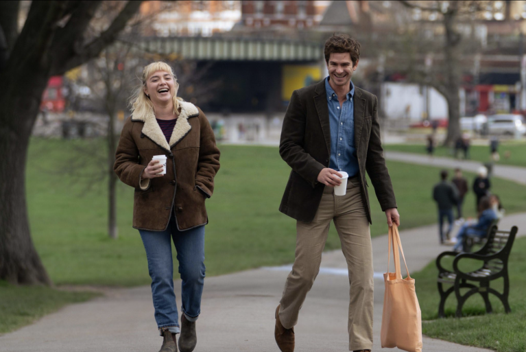 Andrew Garfield and Florence Pugh walking down the street in a still from We Live In Time