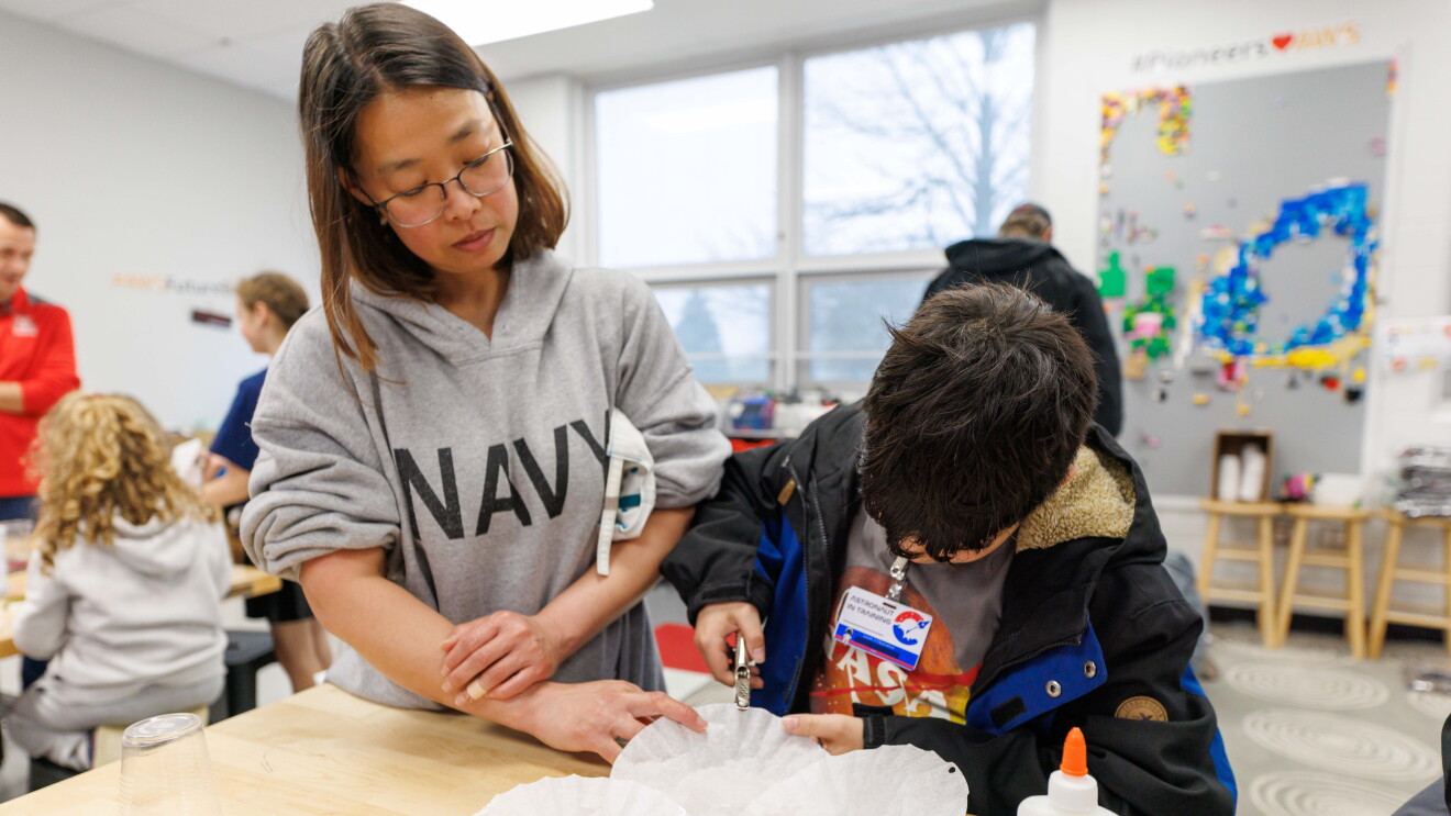 Students collaborating on a craft project in a bright classroom