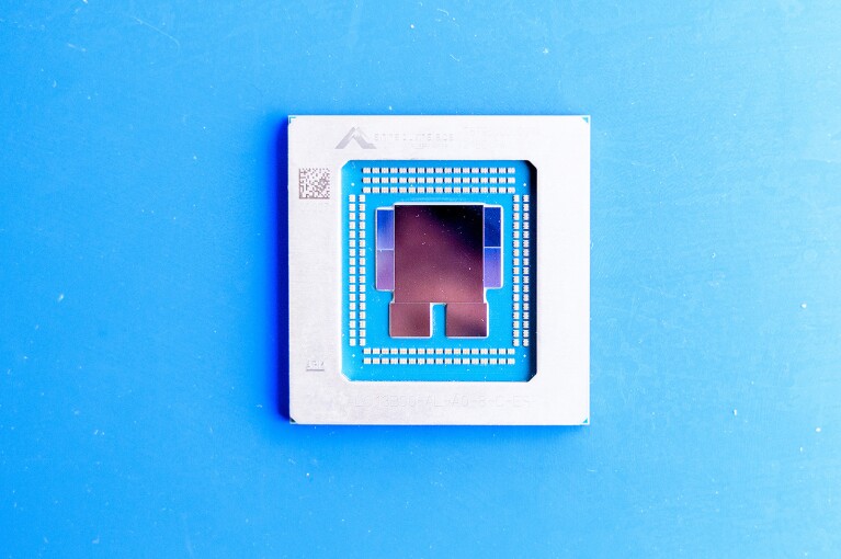 A small, blue and white computer chip pictured against a blue background. 