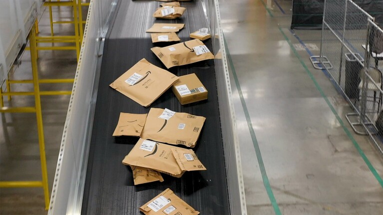 Amazon packages in a conveyer at a fulfillment center.