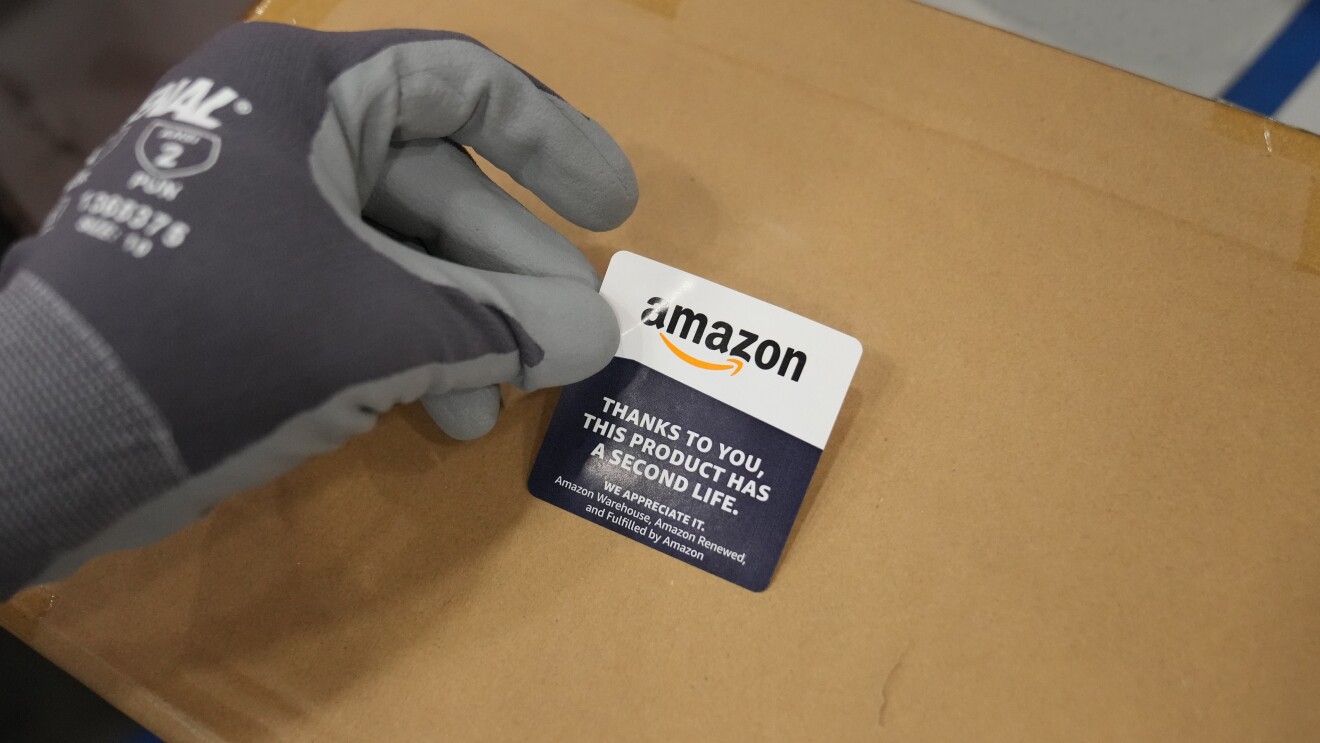 A sticker is placed on to a box filled with Amazon returns that will get a second life.