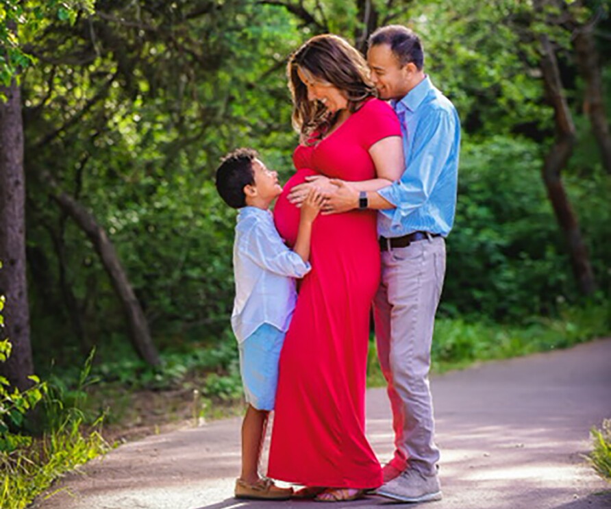 A woman who works at Amazon, poses with her family. 