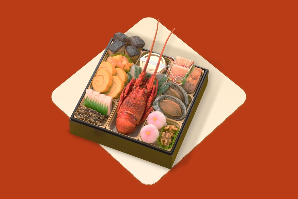 海鮮やたまごなど様々な和食が入ったおせちが白い正方形に置かれている。その正方形が赤い背景に囲まれている。