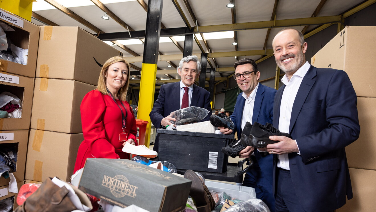Four people, including John Boumphrey and Gordon Brown, handling donations.