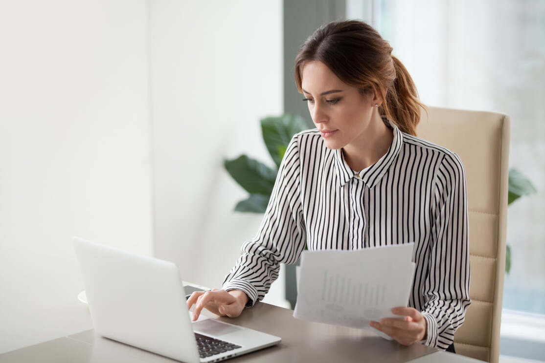 woman with documents and laptop