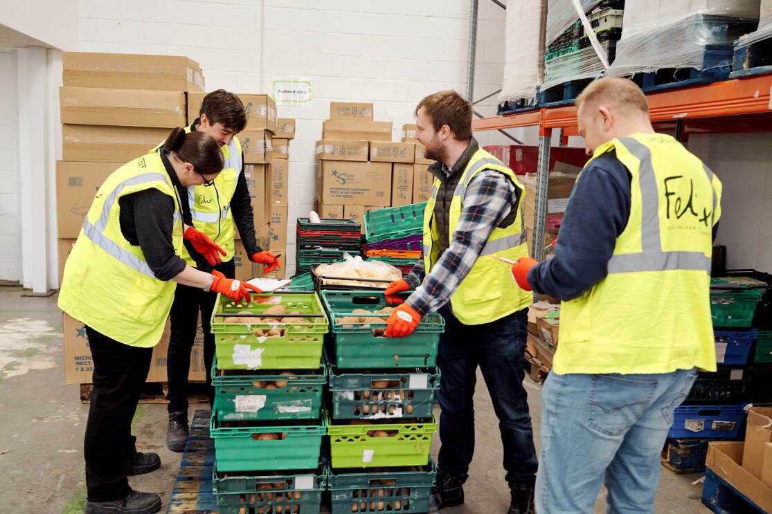 Volunteers work to distribute food for The Felix Project