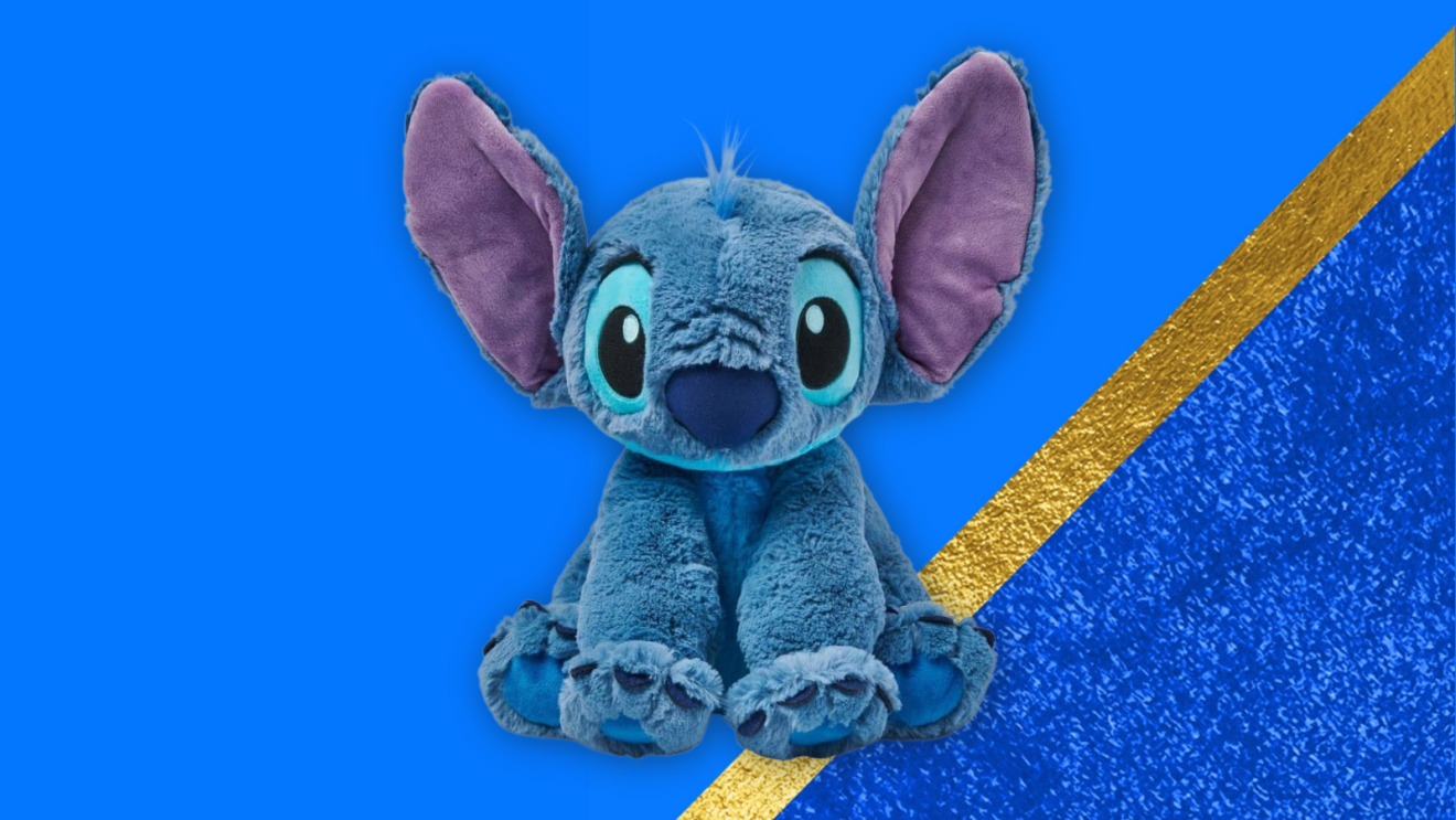 Disney Store Official Stitch Medium Soft Toy against a blue background with a gold stripe.