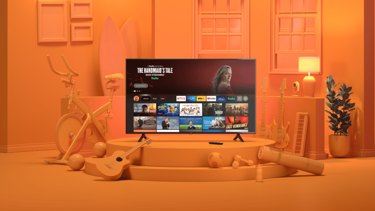 TV displaying streaming services in orange-themed room with exercise bike and guitar