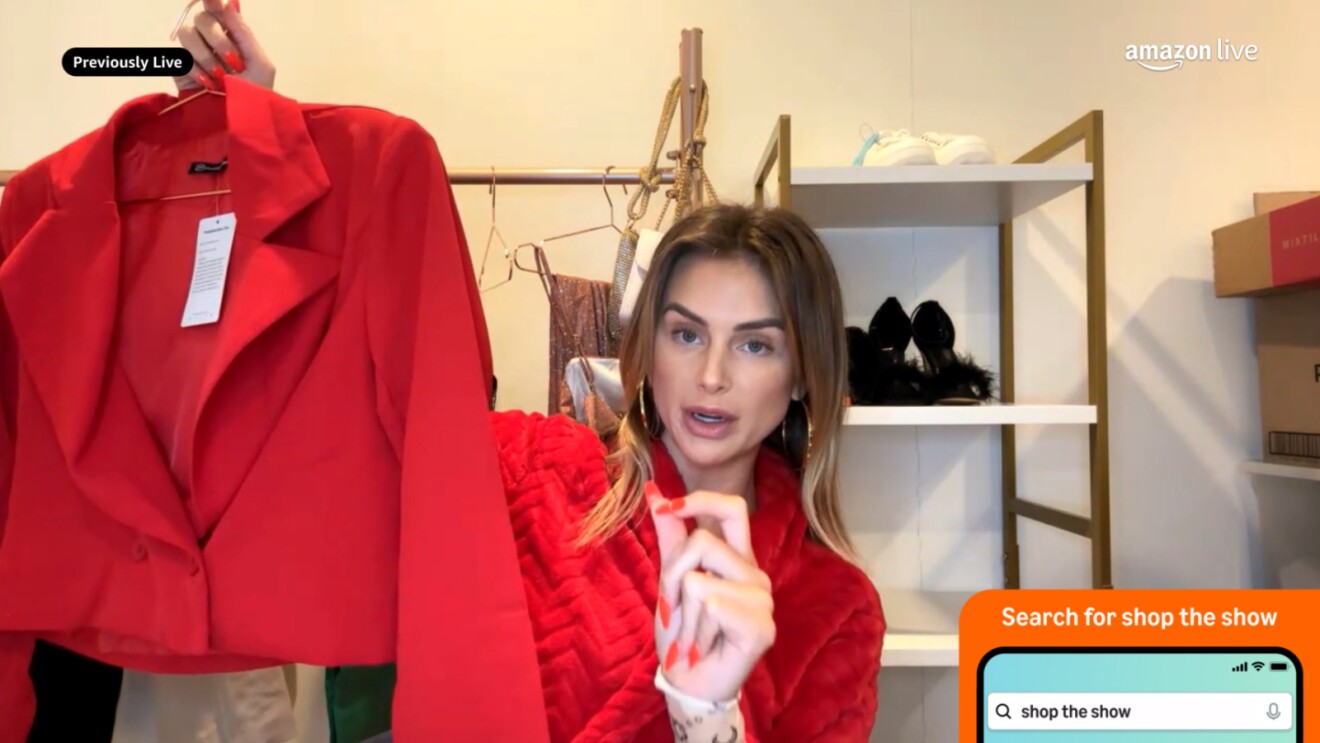 An image of an influencer showing different clothing items to the camera on Amazon Live.