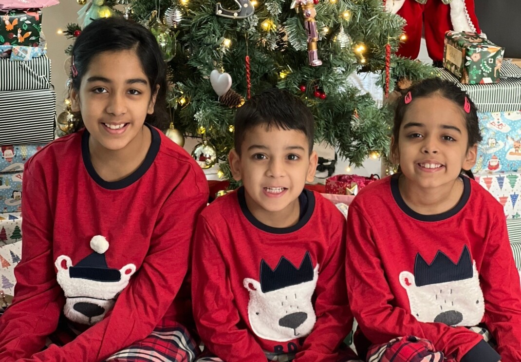 Sharon Kaur's children pictured in front of a Christmas tree