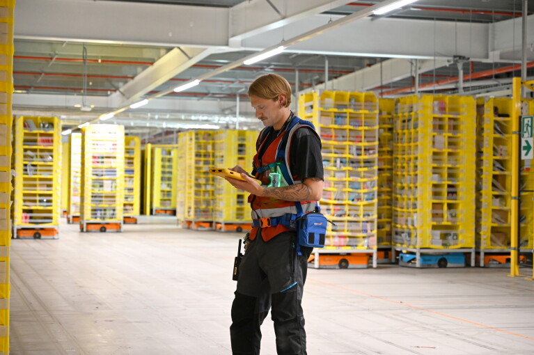 BRS1 employee Geraint Davies with the Amazon smart robots