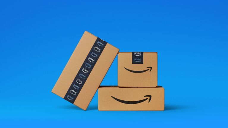 Three Amazon boxes with a blue background.