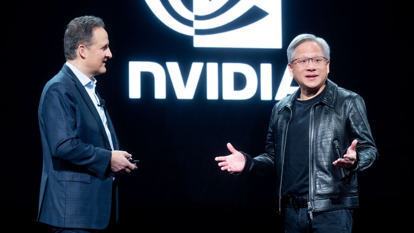 A photo of AWS CEO Adam Selipsky (Left) and NVIDIA CEO Jensen Huang (Right) speaking on stage at AWS re:Invent 2023.