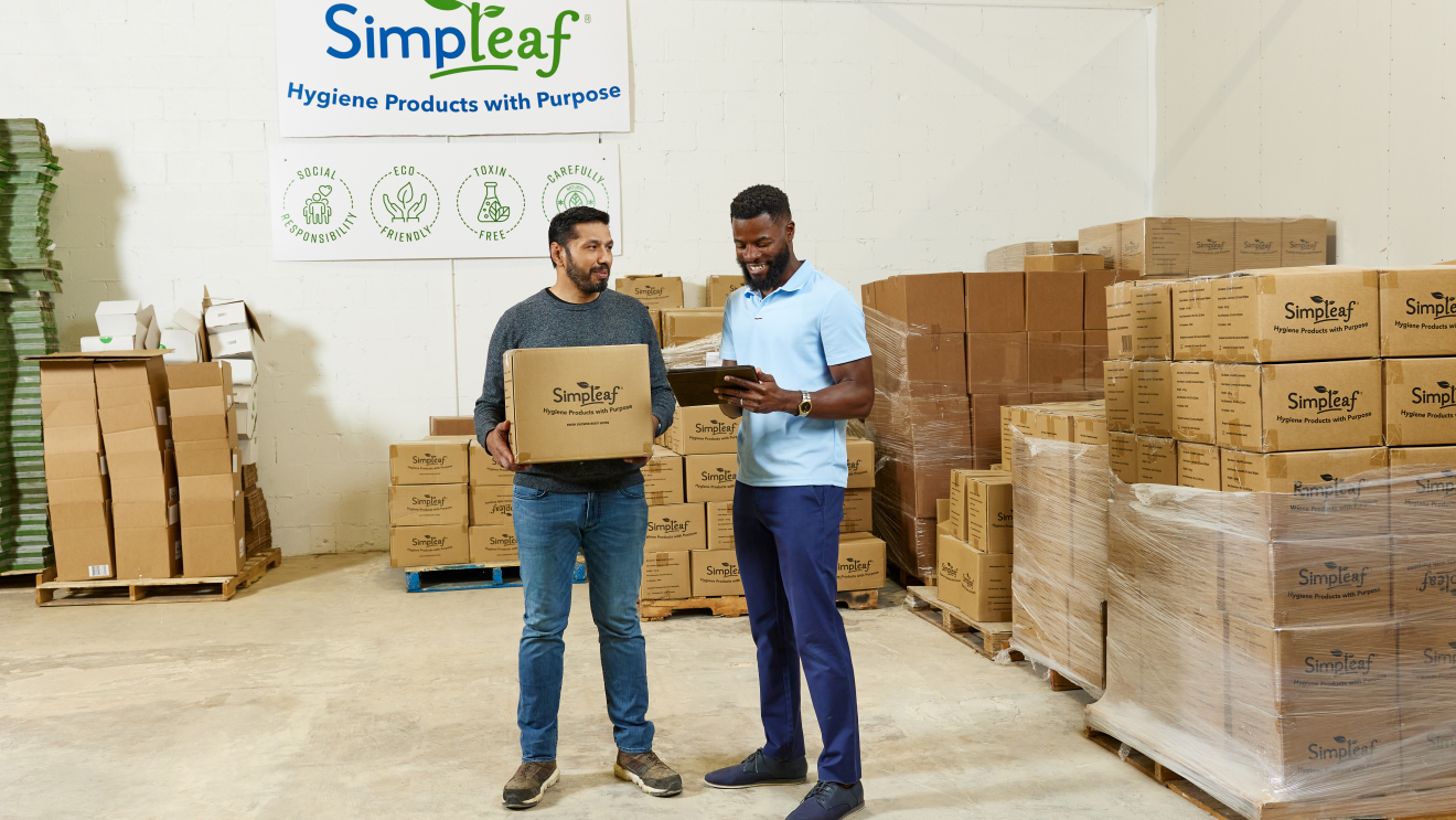 A photo of the owner of Simpleaf, holding a packaging box.