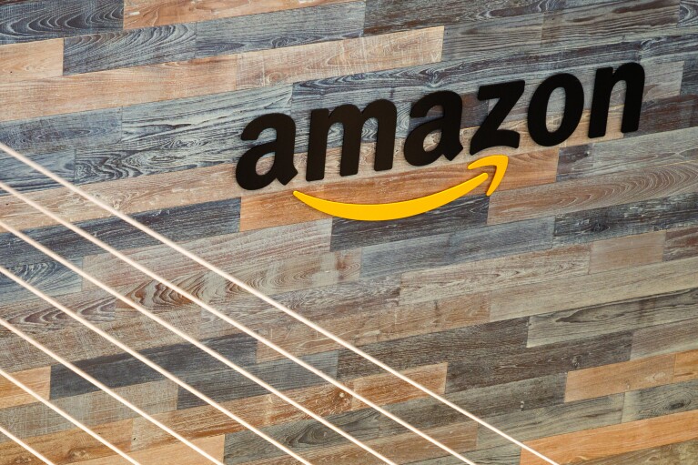 The word amazon in black lettering, with the Amazon Smile in yellow, on a wood plank wall at Amazon's Seattle HQ.