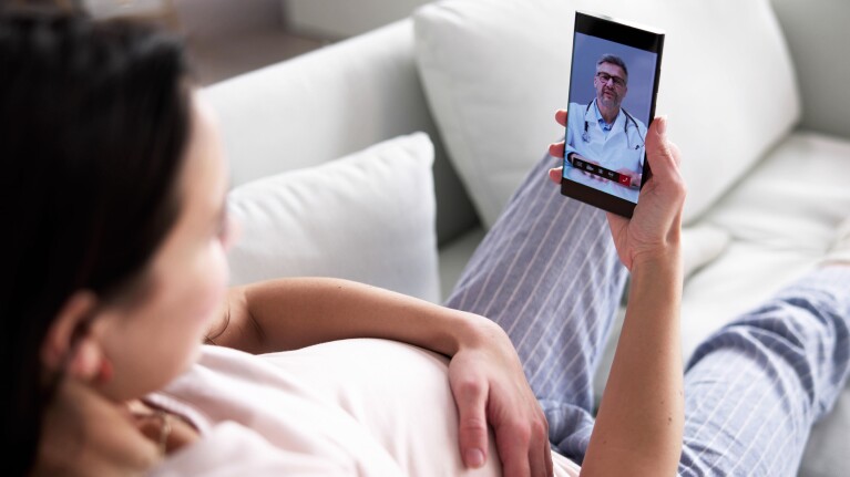 Image of a woman taking a telemedicine appointment on her phone.